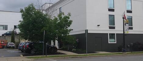 A building with a flat roof, rectangular windows, and a flagpole with a flag.