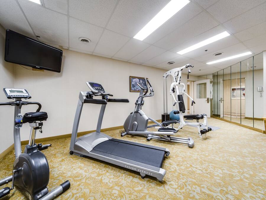 A fitness center with treadmills, an elliptical, and a stationary bike.
