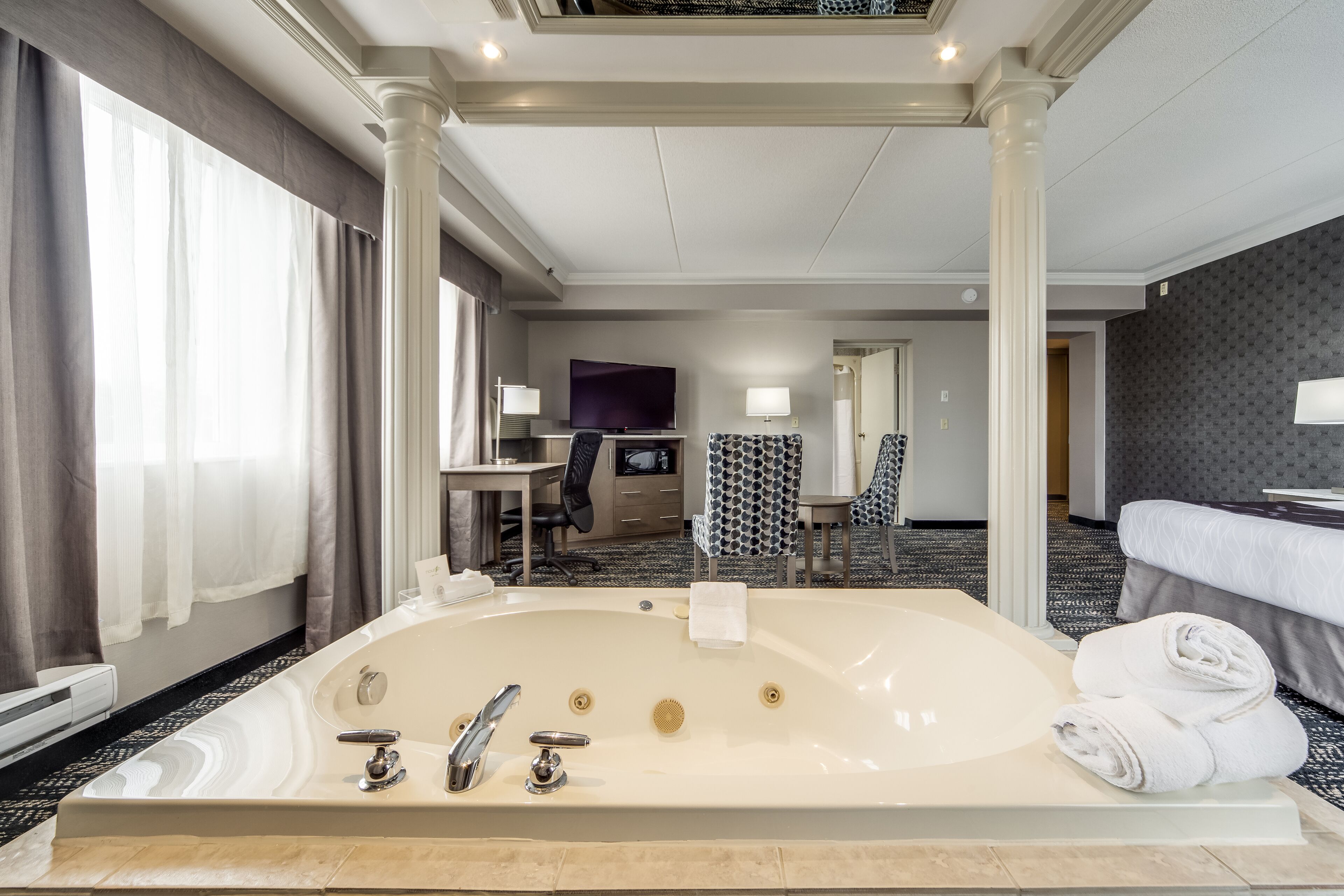 Luxury King Suite with Jetted Tub | Premium bedding, in-room safe, desk, blackout drapes