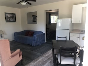 Suite, 1 King Bed, Kitchenette | Living room | Flat-screen TV