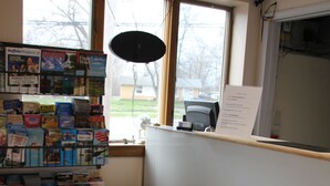 Une librairie avec des étagères remplies de livres, une vitrine et un plancher en bois.