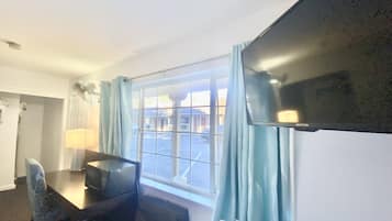 Standard Room, 2 Queen Beds | Living area | 42-inch LED TV with cable channels, TV