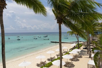 On the beach, sun loungers, beach umbrellas, beach towels at The Reef Coco Beach Resort & Spa- Optional All Inclusive