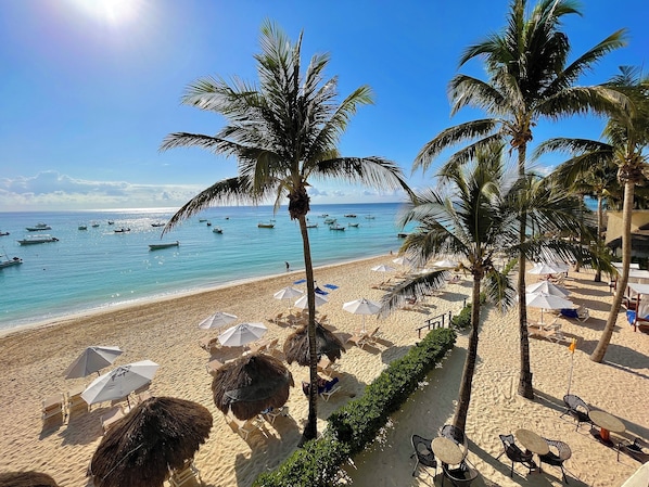 On the beach, sun loungers, beach umbrellas, beach towels