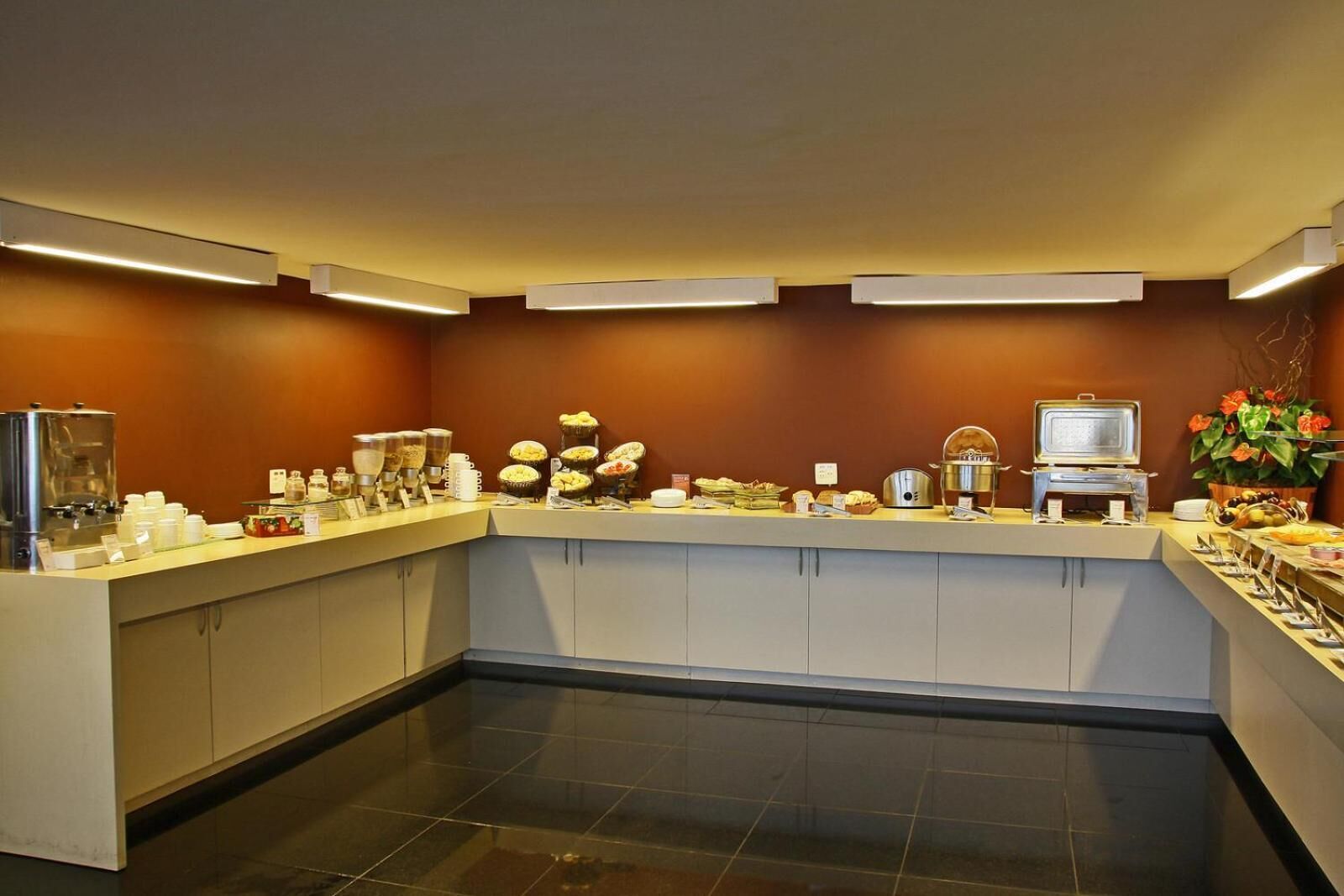 A buffet setup with various food items and a coffee station.