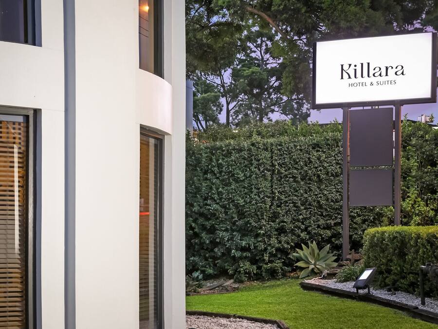 Un edificio moderno con un cartel que indica 'Killara Hotel & Suites'.