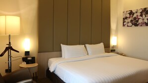 A hotel room with a bed, bedside lamps, a small table, and a chair. - Sunway Hotel Seberang Jaya (Seberang Jaya)