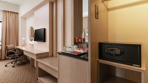 A hotel room with a desk, chair, TV, minibar, and a mirror. - Sunway Hotel Seberang Jaya (Seberang Jaya)