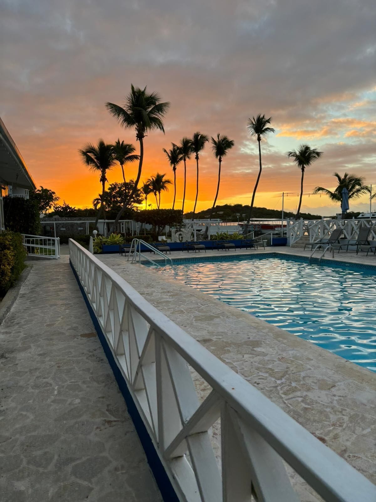 outdoor pool, open 7:00 am to 9:00 pm, pool umbrellas, pool loungers