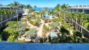 A resort with multiple floors, outdoor pools, and palm trees. - Rincon of the Seas - Grand Caribbean Hotel (Rincon)