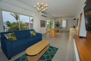 Suite, 1 Bedroom, Kitchenette, Beach View | Living area | 48-inch TV with satellite channels