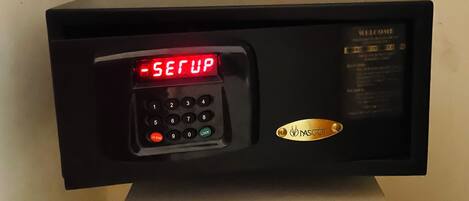 A black electronic device with a keypad and a digital display reading 'SETUP'.