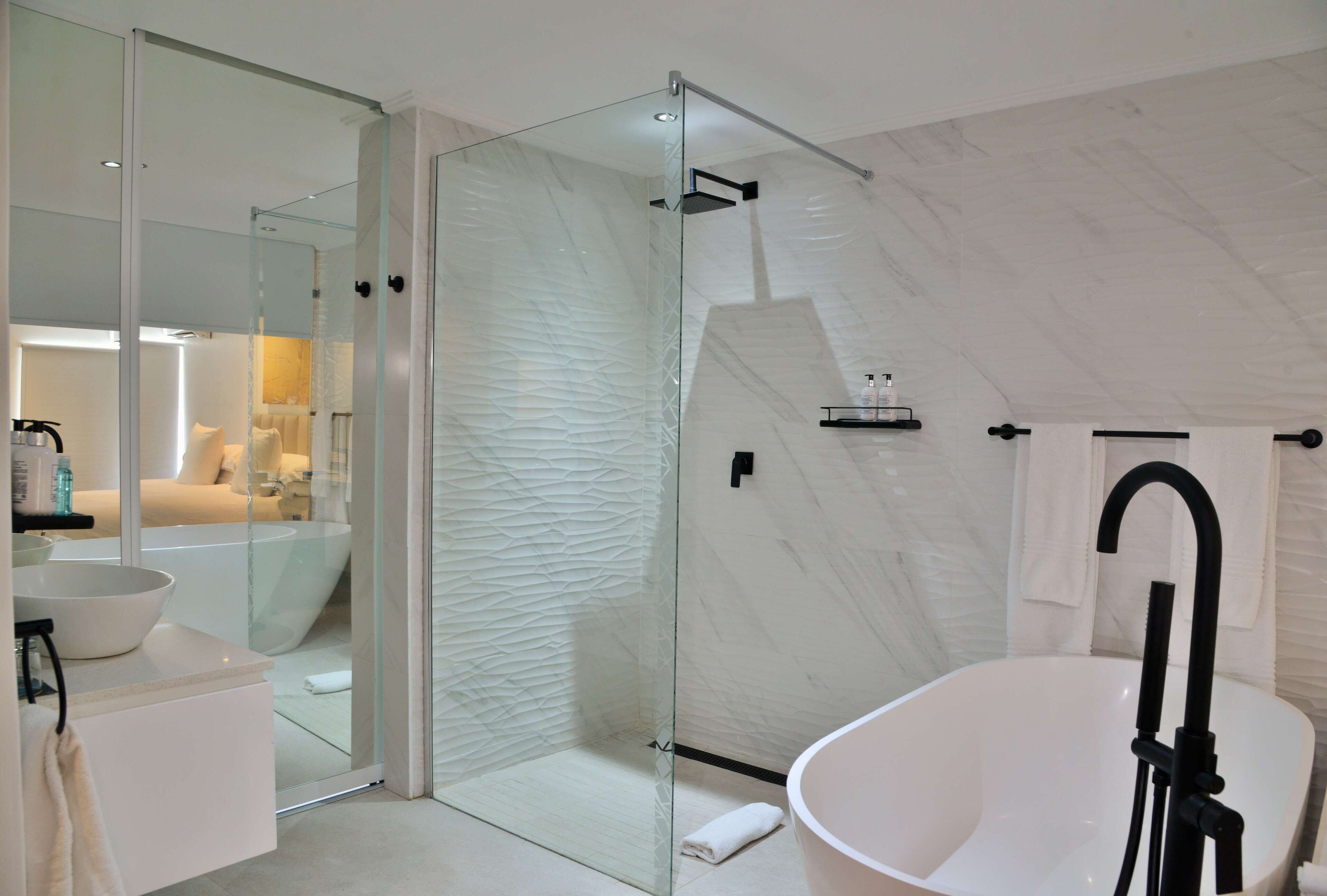 separate bathtub and shower, designer toiletries, hair dryer, bathrobes