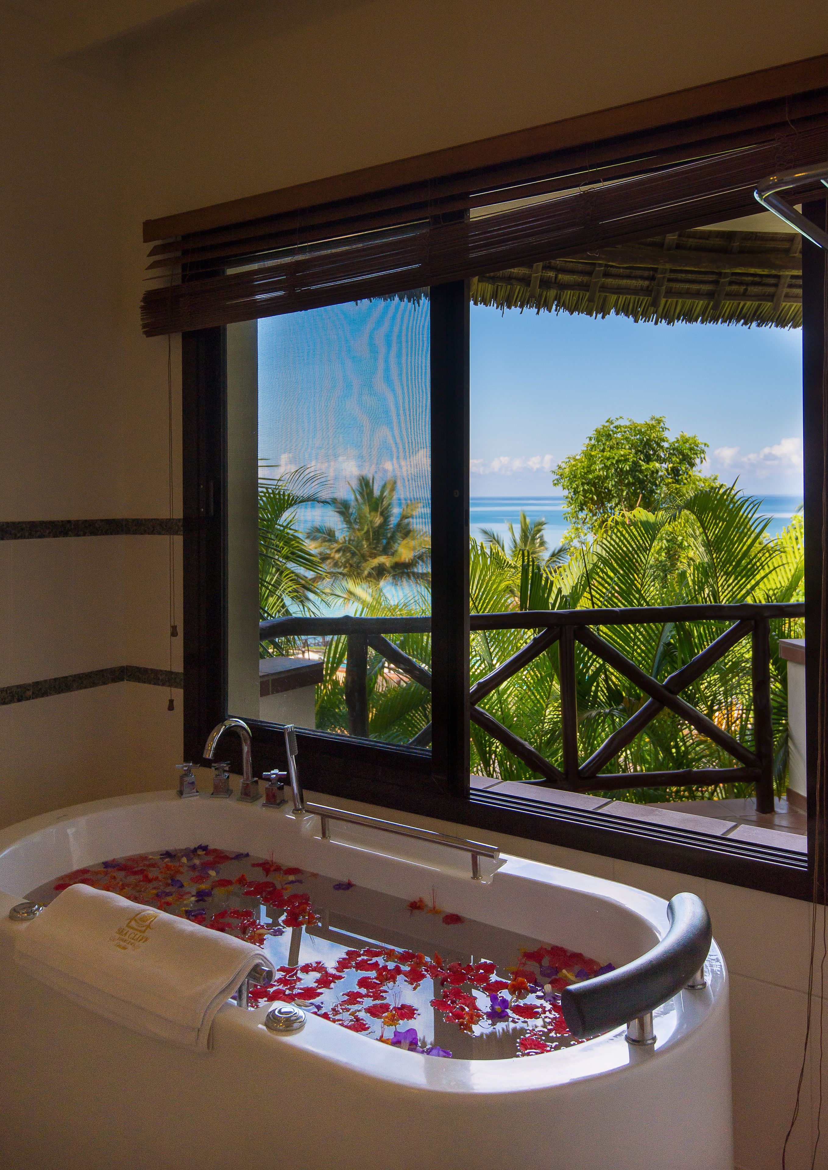 deluxe room | bathroom | shower, rainfall showerhead, free toiletries, hair dryer