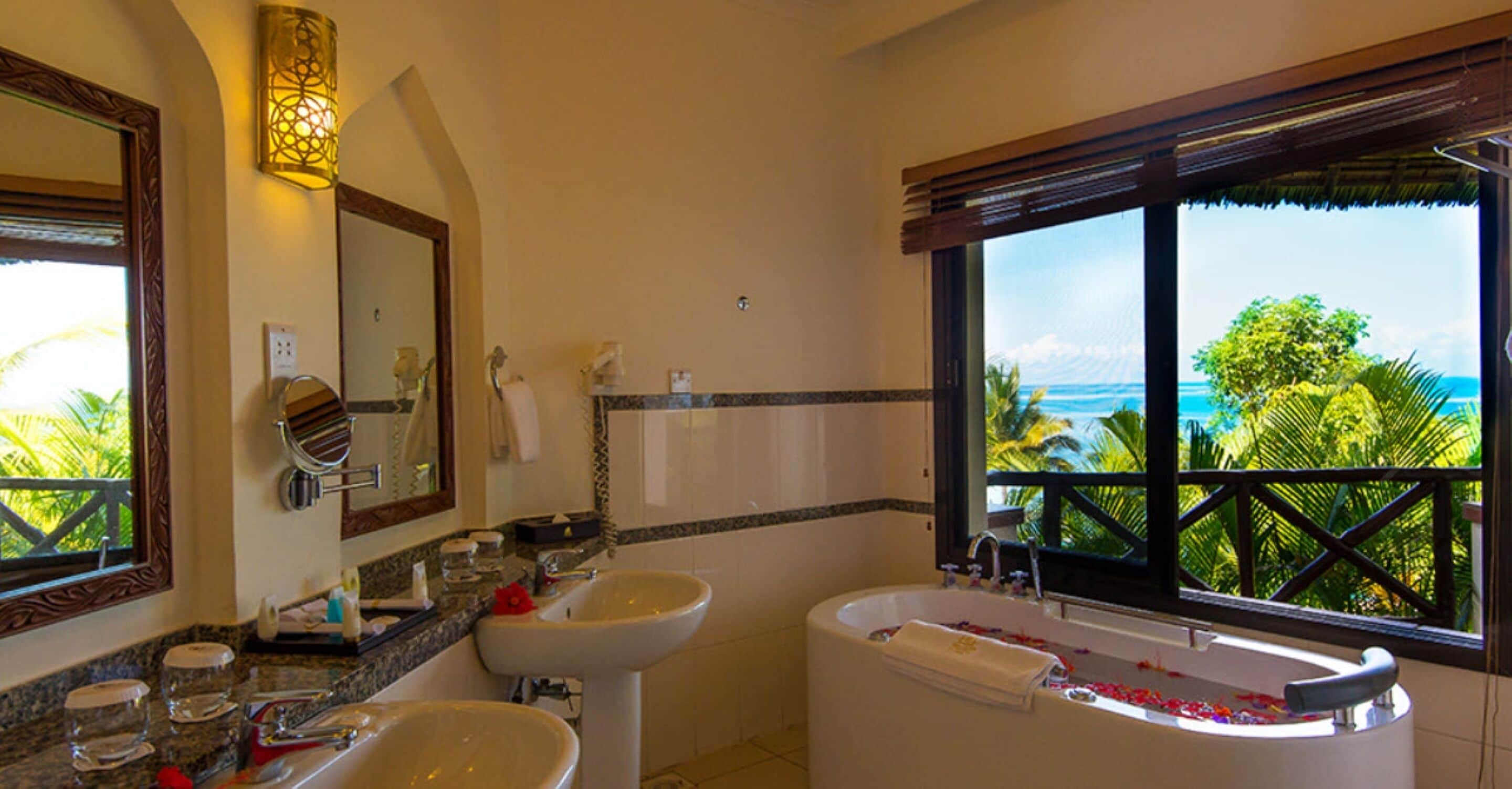 deluxe room | bathroom | shower, rainfall showerhead, free toiletries, hair dryer