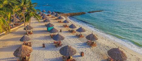 Private beach, white sand, sun loungers, beach umbrellas