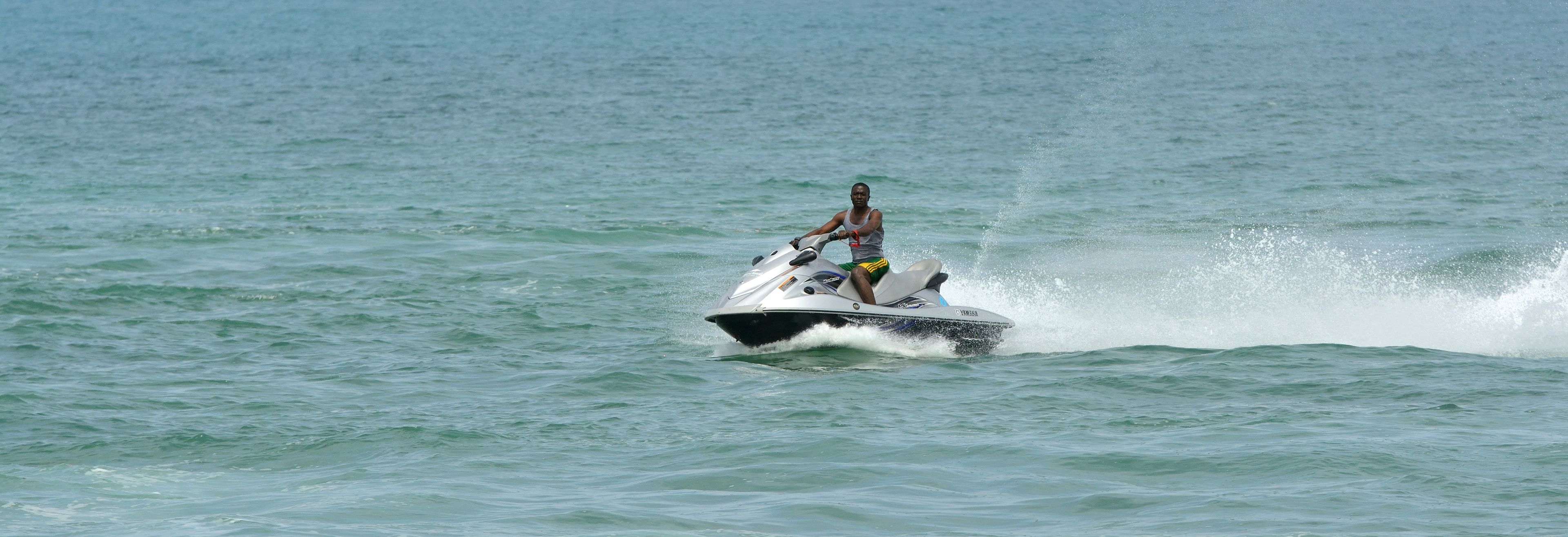 A person riding a jet ski on a body of water.