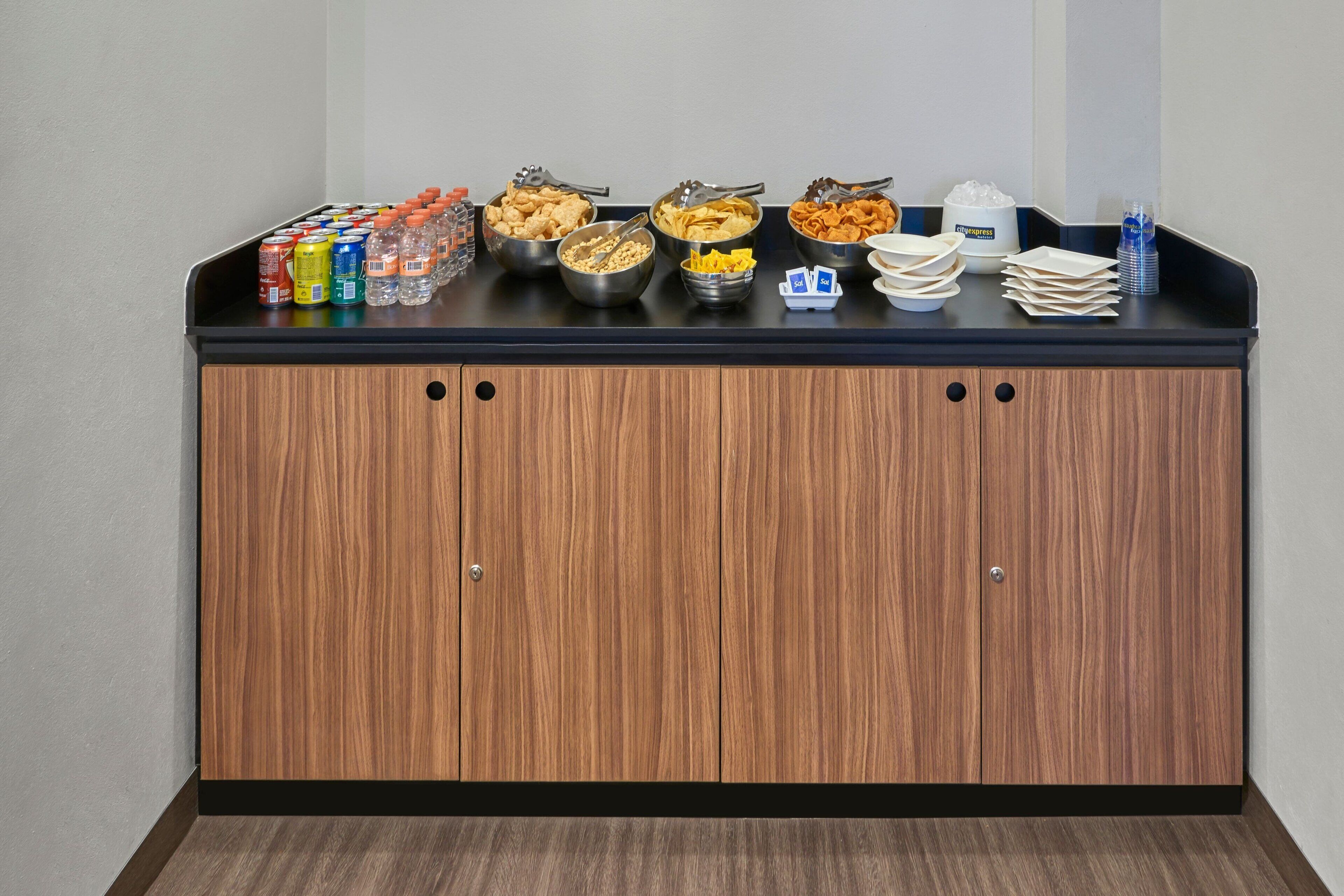 A buffet setup with various food items and beverages.