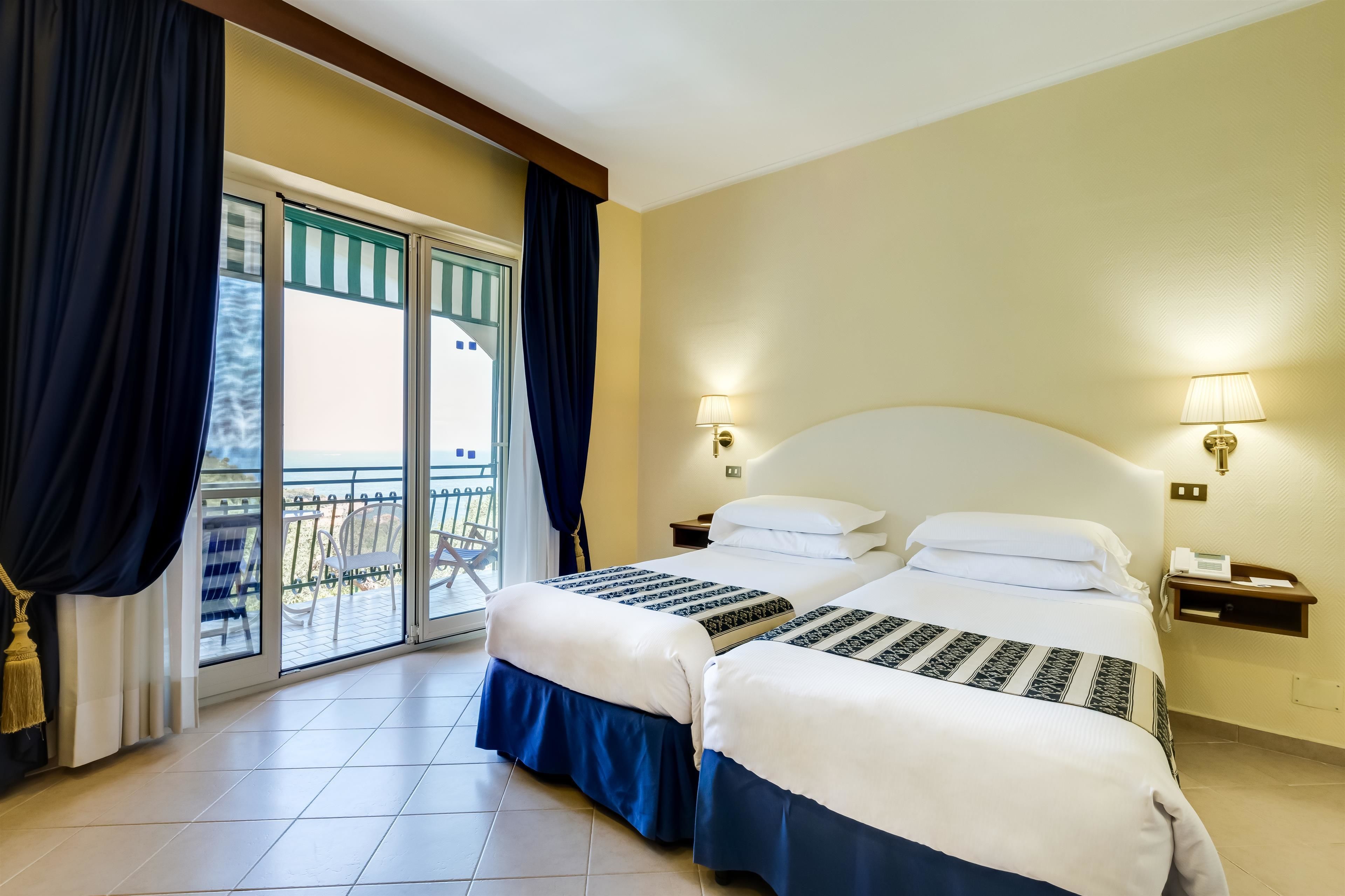 classic room, multiple beds, balcony, sea view | 1 bedroom, minibar, in-room safe, desk