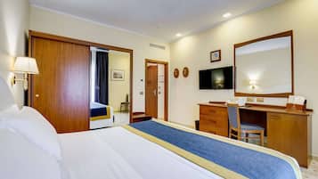 Relax in this spacious room with a large bed, desk, and TV, perfect for unwinding after a long day.