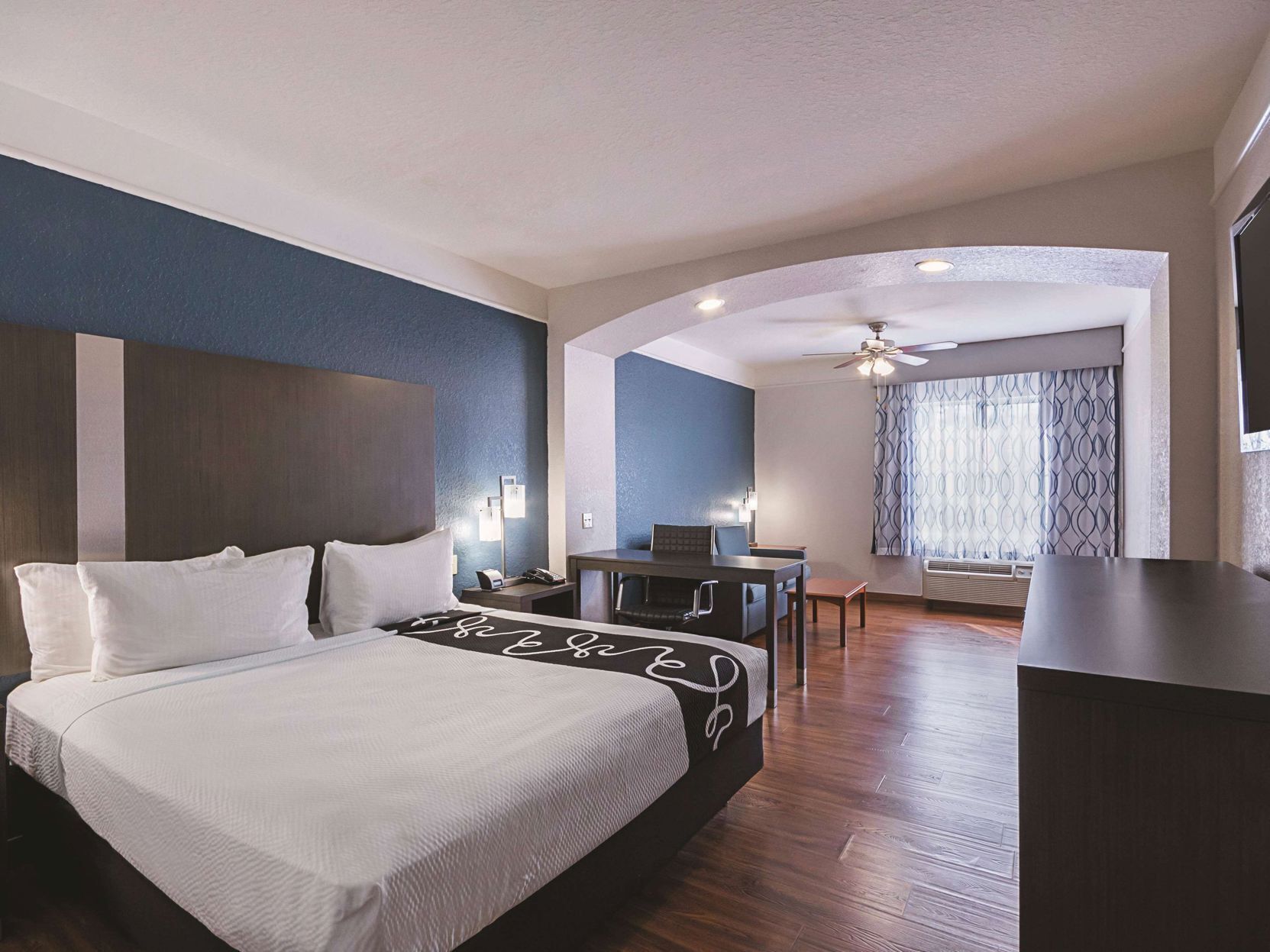 Premium bedding, desk, laptop workspace, blackout curtains