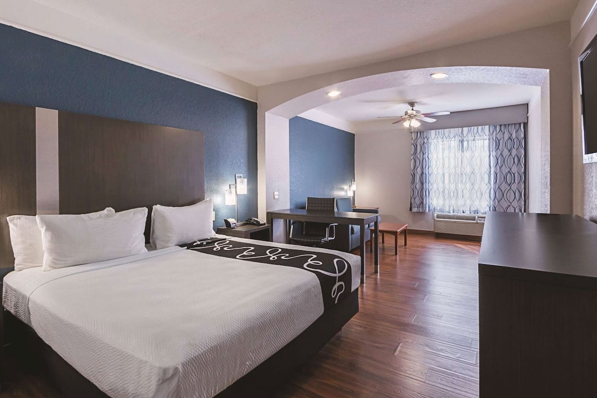 Premium bedding, desk, laptop workspace, blackout curtains