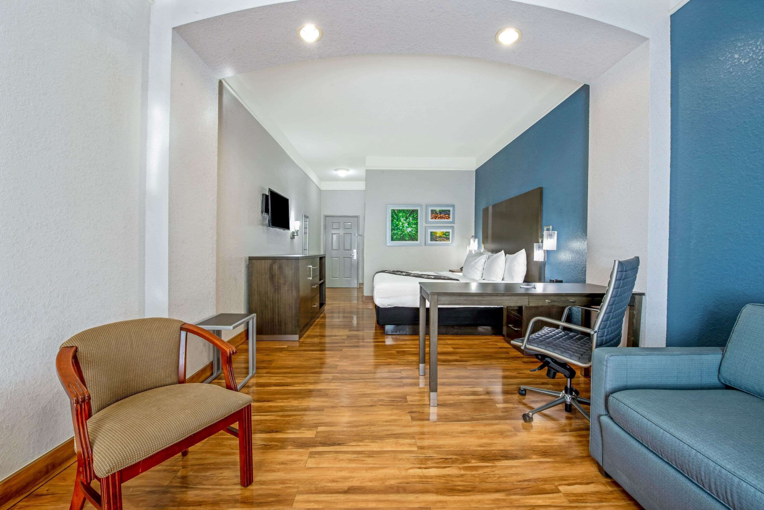 Premium bedding, desk, laptop workspace, blackout drapes