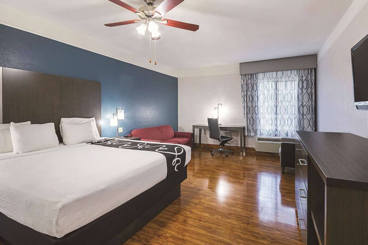 Premium bedding, desk, laptop workspace, blackout curtains