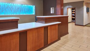 A reception desk with a wooden finish, a blue abstract wall art, and a 'Corner Market' sign. - Fairfield Inn & Suites by Marriott Frankfort (Frankfort)