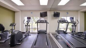 A gym with treadmills, an elliptical, and a stationary bike.