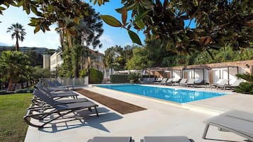 Seasonal outdoor pool, open 9:00 AM to 8:00 PM, pool umbrellas