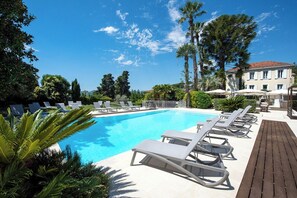 Seasonal outdoor pool, open 9:00 AM to 8:00 PM, pool umbrellas