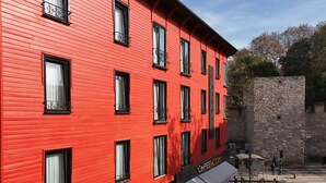 A red building with multiple windows and a sign for a coffee factory. - Navoris Hotel (Istanbul)