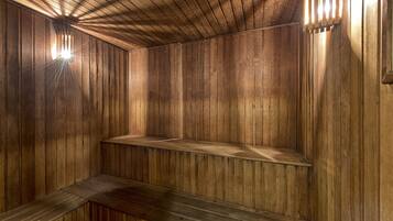 A wooden interior with slatted walls and a bench.
