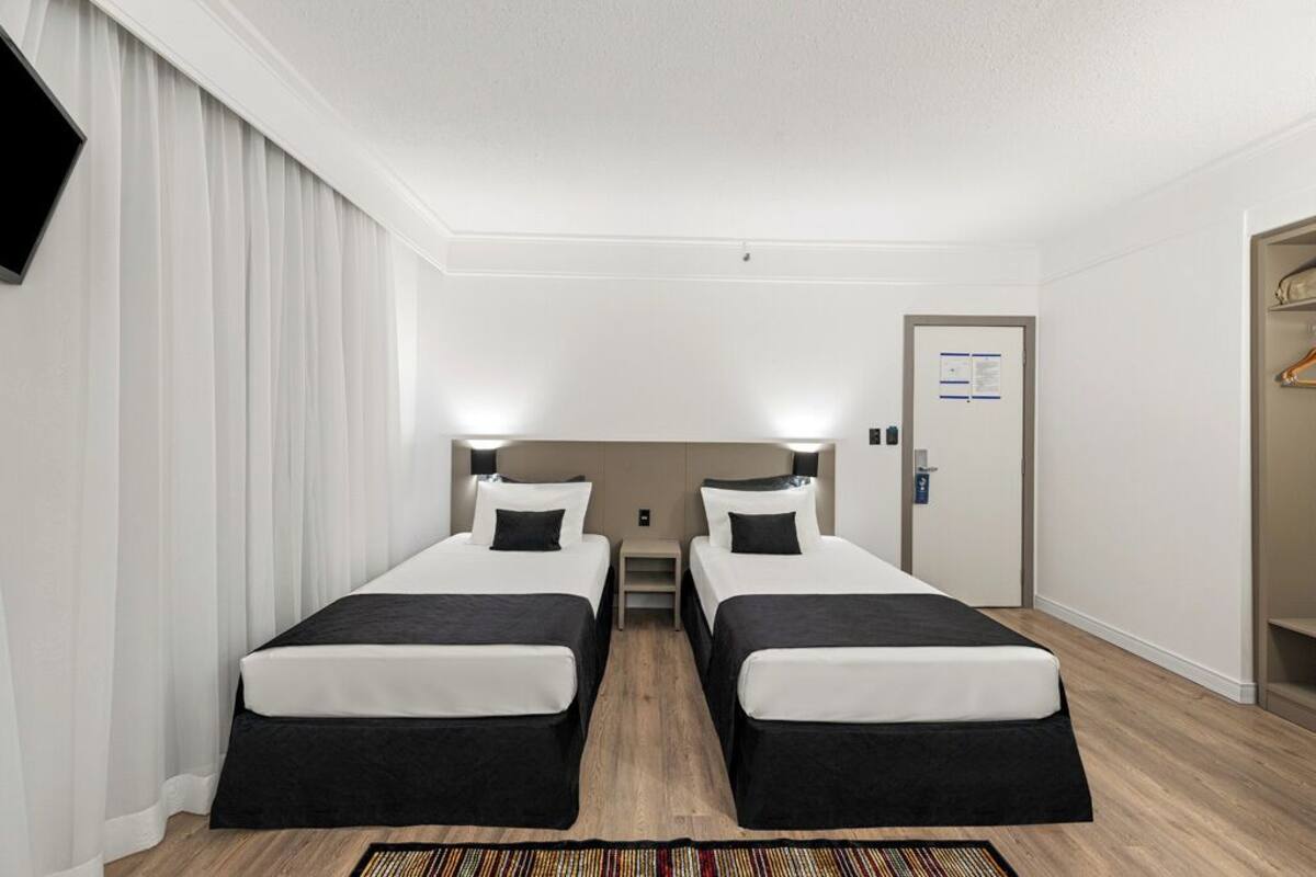 Superior Triple Room | Minibar, in-room safe, desk, blackout drapes