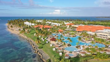 A resort with a large pool, beach, and ocean views.
