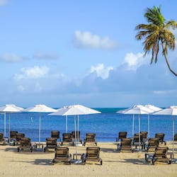 On the beach, white sand, sun loungers, beach umbrellas