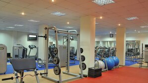 A gym with weightlifting equipment, exercise balls, and treadmills. - Stratton Hotel Asokoro (Abuja)