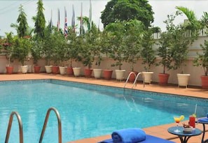 Outdoor pool, open 7:00 AM to 8:00 PM, pool umbrellas, pool loungers