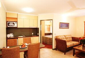 Suite, 1 Bedroom | Desk, iron/ironing board, cots/infant beds, free WiFi - Bay Village Tropical Retreat & Apartments (Cairns North)
