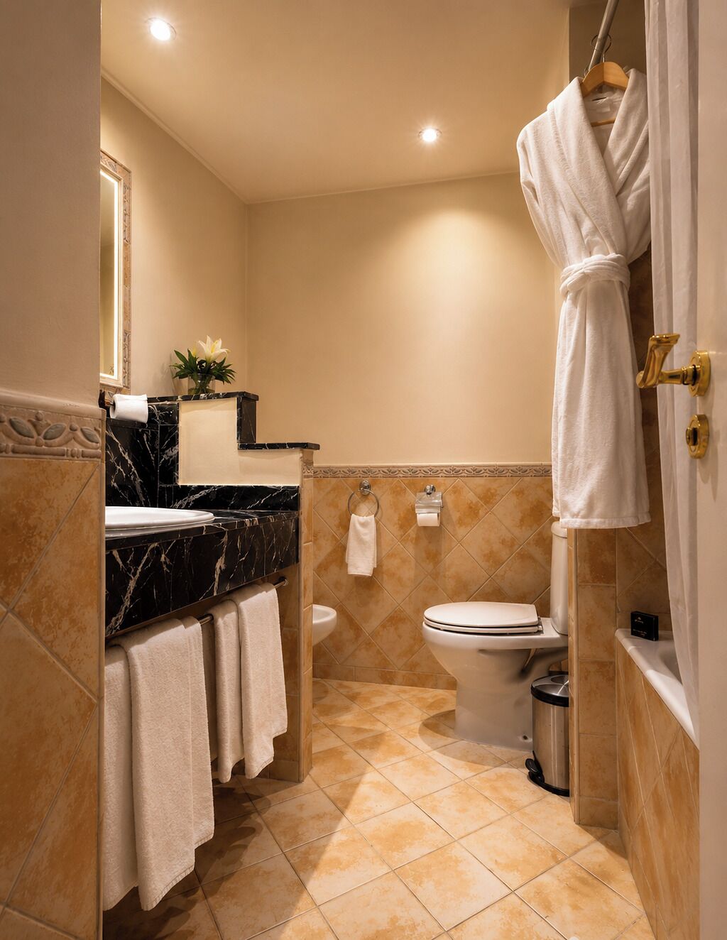 A bathroom with a marble sink, toilet, and a bathtub with a shower curtain.