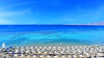 On the beach, sun loungers, beach towels, beach volleyball