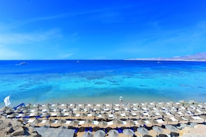 On the beach, sun loungers, beach towels, beach volleyball