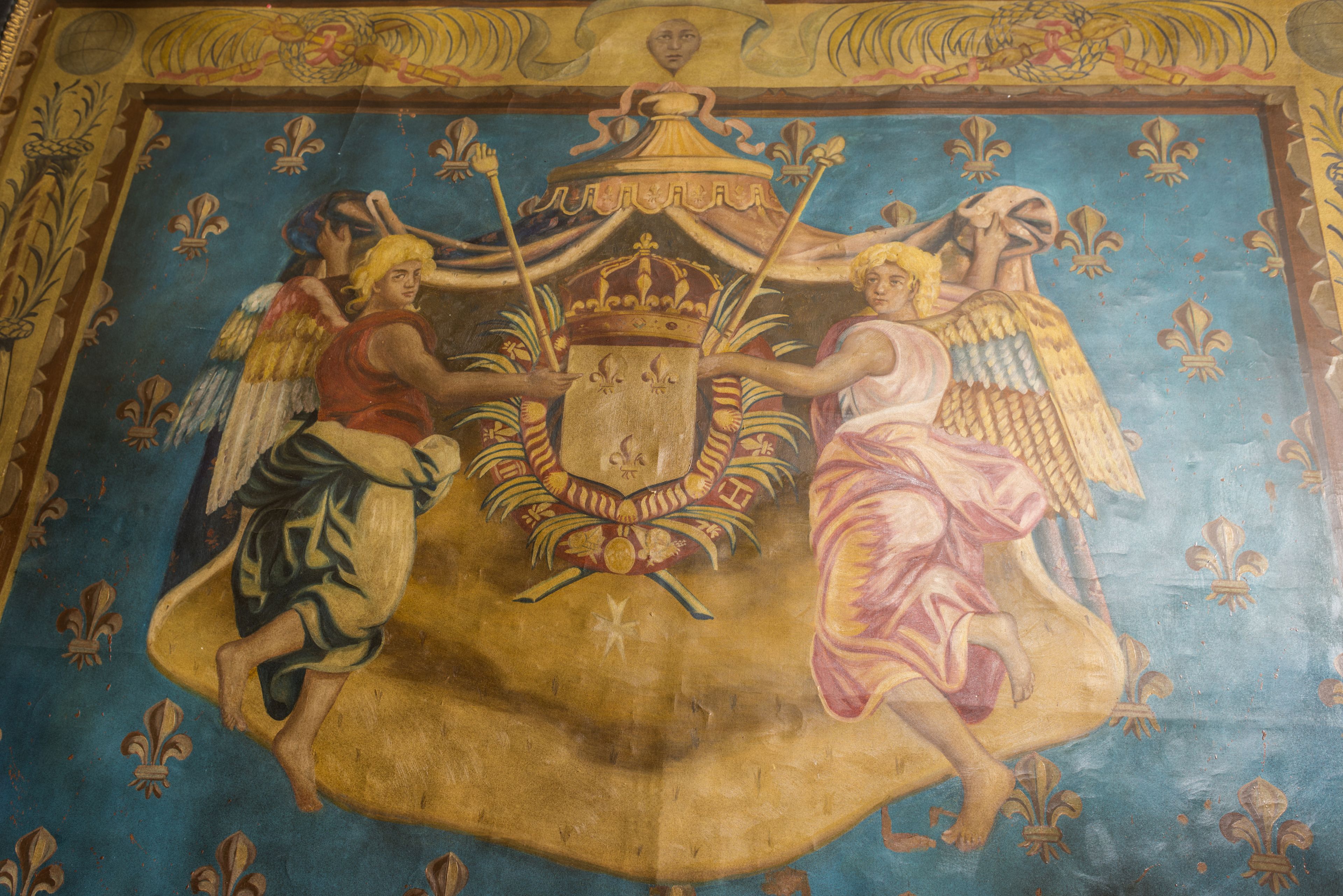 A detailed mural with figures and a crown.