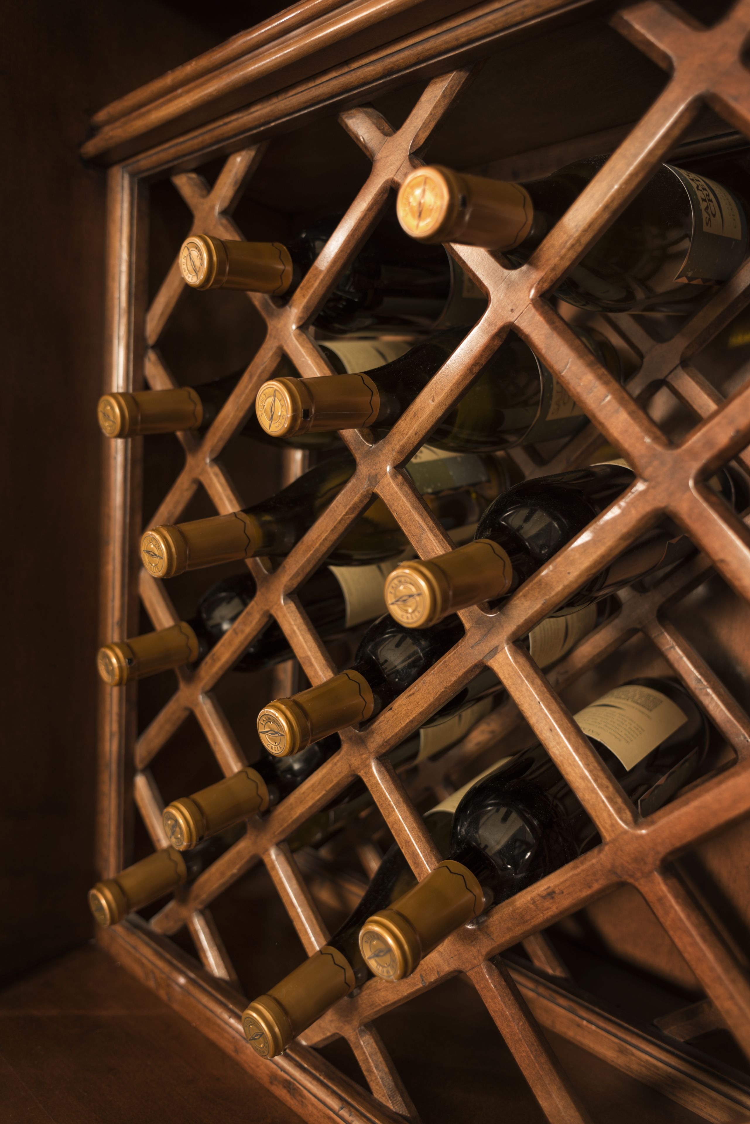 A wine rack with multiple bottles.