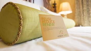 A pillow with a card on it that says "REUSE REDUCE RENEW" and "AYRES CARES".