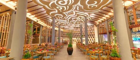 A spacious indoor area with high ceilings, large columns, and a central walkway.