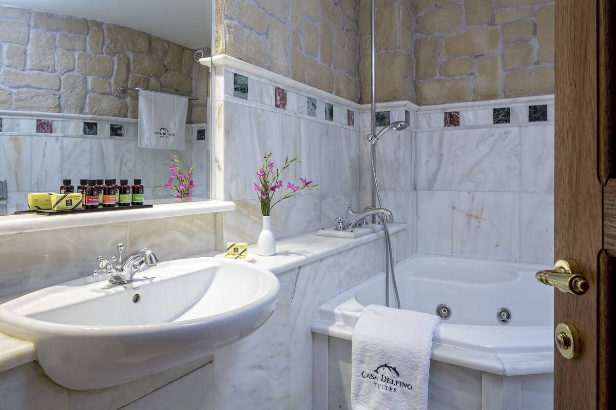 family suite | bathroom | deep-soaking bathtub, eco-friendly toiletries, hair dryer, bathrobes
