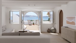 A modern room with a large window, a sofa, a small table, and a radiator.