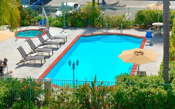 In-room safe, desk, laptop workspace, blackout drapes at Cortona Inn & Suites Anaheim Resort